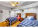 Comfortable bedroom featuring twin beds, hardwood floors, and bright, natural lighting at 154 Godfrey Rd, Edgewater, FL 32141