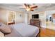 Bright bedroom features a large bed frame, coffered ceiling, and an ensuite bathroom with tiled shower at 154 Godfrey Rd, Edgewater, FL 32141