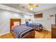 Cozy bedroom with twin beds, wooden floors, and a ceiling fan providing a relaxing ambiance at 154 Godfrey Rd, Edgewater, FL 32141