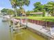 Waterfront home featuring a private dock with boat lift and lush backyard at 154 Godfrey Rd, Edgewater, FL 32141