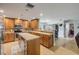 Open kitchen with a central island, wooden cabinetry, and a view into the dining area at 154 Godfrey Rd, Edgewater, FL 32141