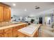 Open-concept kitchen with a center island sink, flowing into a spacious living area with light blue walls at 154 Godfrey Rd, Edgewater, FL 32141