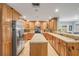Functional kitchen with wood cabinets, stainless steel refrigerator, and a convenient breakfast bar at 154 Godfrey Rd, Edgewater, FL 32141