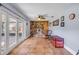 Bright living room with a decorative stone fireplace, tile flooring, and glass doors to the outside at 154 Godfrey Rd, Edgewater, FL 32141