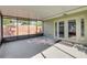 Neutral rug under an enclosed patio featuring screen windows and a set of glass french doors at 154 Godfrey Rd, Edgewater, FL 32141