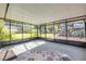 Screened in porch with views of the exterior yard space, surrounded by a black metal frame at 154 Godfrey Rd, Edgewater, FL 32141