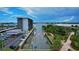 Aerial view of waterfront condo featuring boat docks and parking, located near scenic river and a bridge at 101 N Riverside Dr # 1090, New Smyrna Beach, FL 32168