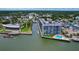 Beautiful aerial view of a waterfront condo building with a pool and marina at 101 N Riverside Dr # 1090, New Smyrna Beach, FL 32168