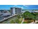 Aerial view of the condo building's waterfront location, with boat docks, and ample parking spaces at 101 N Riverside Dr # 1090, New Smyrna Beach, FL 32168
