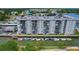 Aerial view of a waterfront condo that includes boat docks, landscaping, a pool, and balconies at 101 N Riverside Dr # 1090, New Smyrna Beach, FL 32168