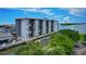 High angle view of condo building on the water with boat docks and lush green landscaping on a sunny day at 101 N Riverside Dr # 1090, New Smyrna Beach, FL 32168