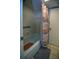 Well-maintained bathroom with tiled shower featuring safety bar and neutral colored shower curtain at 101 N Riverside Dr # 1090, New Smyrna Beach, FL 32168