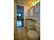 Bathroom with a vanity, toilet, tile floors, and a view into an adjacent bedroom at 101 N Riverside Dr # 1090, New Smyrna Beach, FL 32168