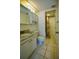Bathroom features a vanity with a marble countertop and a shower with patterned curtains at 101 N Riverside Dr # 1090, New Smyrna Beach, FL 32168
