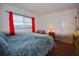 Inviting bedroom features a bright window, hardwood floors, and a side table with lamp at 101 N Riverside Dr # 1090, New Smyrna Beach, FL 32168