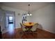 Charming dining area with a wood table, four chairs, and a stylish chandelier lighting fixture at 101 N Riverside Dr # 1090, New Smyrna Beach, FL 32168