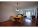 Dining room with hardwood floors and views into the living room at 101 N Riverside Dr # 1090, New Smyrna Beach, FL 32168