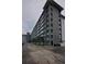 Multi-story condominium building with private balconies, on-site parking, and scenic landscaping on a cloudy day at 101 N Riverside Dr # 1090, New Smyrna Beach, FL 32168