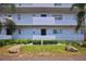 Three-story condominium exterior showcasing well-maintained landscaping and stone features, perfect for tranquil living at 101 N Riverside Dr # 1090, New Smyrna Beach, FL 32168