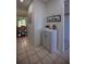 Hallway view into dining and living rooms with tile flooring and white walls at 101 N Riverside Dr # 1090, New Smyrna Beach, FL 32168