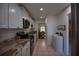 Modern galley kitchen with white cabinetry, stainless steel appliances, granite countertops, and tile flooring at 101 N Riverside Dr # 1090, New Smyrna Beach, FL 32168