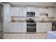 Bright kitchen with stainless steel appliances, white cabinets, and light countertops at 101 N Riverside Dr # 1090, New Smyrna Beach, FL 32168