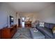 Open-concept living room featuring modern furniture and a view into the dining and kitchen areas at 101 N Riverside Dr # 1090, New Smyrna Beach, FL 32168
