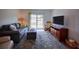 Cozy living room with large TV, rocking chair, and comfortable seating with exterior access at 101 N Riverside Dr # 1090, New Smyrna Beach, FL 32168