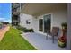 Condo patio boasts sliding glass doors, outside seating, and views of lush green grass and the waterfront at 101 N Riverside Dr # 1090, New Smyrna Beach, FL 32168