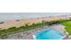 An aerial picture of a pool with sun loungers overlooking the ocean at 1051 Ocean Shore Blvd # 502, Ormond Beach, FL 32176
