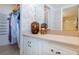 Bathroom with white vanity, mirror, and tile flooring, next to a walk-in closet at 1051 Ocean Shore Blvd # 502, Ormond Beach, FL 32176