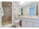 Well-lit bathroom featuring a shower with glass door, and vanity with white cabinetry at 1051 Ocean Shore Blvd # 502, Ormond Beach, FL 32176