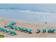 Picturesque beach setting with neatly arranged beach chairs and umbrellas, inviting relaxation by the sea at 1051 Ocean Shore Blvd # 502, Ormond Beach, FL 32176