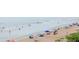 Expansive beach view featuring beachgoers, tents, and calm ocean waters, perfect for recreation at 1051 Ocean Shore Blvd # 502, Ormond Beach, FL 32176