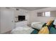 Bedroom with two beds, a white dresser, and a small window for natural light at 1051 Ocean Shore Blvd # 502, Ormond Beach, FL 32176