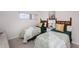Bedroom featuring two twin beds, a small window, and neutral colored walls at 1051 Ocean Shore Blvd # 502, Ormond Beach, FL 32176