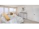 Bright bedroom featuring a balcony with ocean views, dresser, and comfortable furnishings at 1051 Ocean Shore Blvd # 502, Ormond Beach, FL 32176