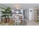 Bright dining area features a round table, seating for four, and decorous cabinet on hardwood floor at 1051 Ocean Shore Blvd # 502, Ormond Beach, FL 32176