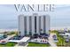 A luxury white high-rise condo building, named Van Lee, sits on a beach with a parking lot in front and ocean views at 1051 Ocean Shore Blvd # 502, Ormond Beach, FL 32176