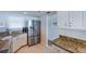 Updated kitchen featuring granite countertops, stainless steel appliances, and white cabinetry at 1051 Ocean Shore Blvd # 502, Ormond Beach, FL 32176