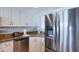 Updated kitchen featuring granite countertops, stainless steel appliances, and white cabinetry at 1051 Ocean Shore Blvd # 502, Ormond Beach, FL 32176