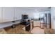 Bright kitchen with white cabinetry, granite countertops, and stainless steel appliances at 1051 Ocean Shore Blvd # 502, Ormond Beach, FL 32176
