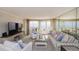 Spacious living room boasts ocean view, comfortable seating and a large television at 1051 Ocean Shore Blvd # 502, Ormond Beach, FL 32176