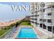 Tranquil pool with direct ocean views, surrounded by lounge chairs and condo balconies in a beachside retreat at 1051 Ocean Shore Blvd # 502, Ormond Beach, FL 32176