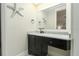 Bathroom vanity with marble countertop, dark cabinets, sleek fixtures, and starfish decorations at 1212 S Riverside Dr, New Smyrna Beach, FL 32168