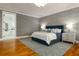 Primary bedroom featuring a queen bed, hardwood flooring, lamps, a ceiling fan and neutral paint at 1212 S Riverside Dr, New Smyrna Beach, FL 32168