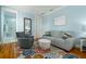 Bright blue bedroom with a seating area and en-suite bathroom at 1212 S Riverside Dr, New Smyrna Beach, FL 32168