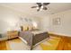 Inviting bedroom with a cozy bed, decorative pillows, ceiling fan, and stylish décor at 1212 S Riverside Dr, New Smyrna Beach, FL 32168