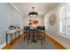 Chic dining room features patterned wallpaper, modern light fixtures, and a stylish bar area at 1212 S Riverside Dr, New Smyrna Beach, FL 32168