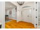 Bright foyer featuring a white front door flanked by sidelights, wood floors and an elegant light fixture at 1212 S Riverside Dr, New Smyrna Beach, FL 32168